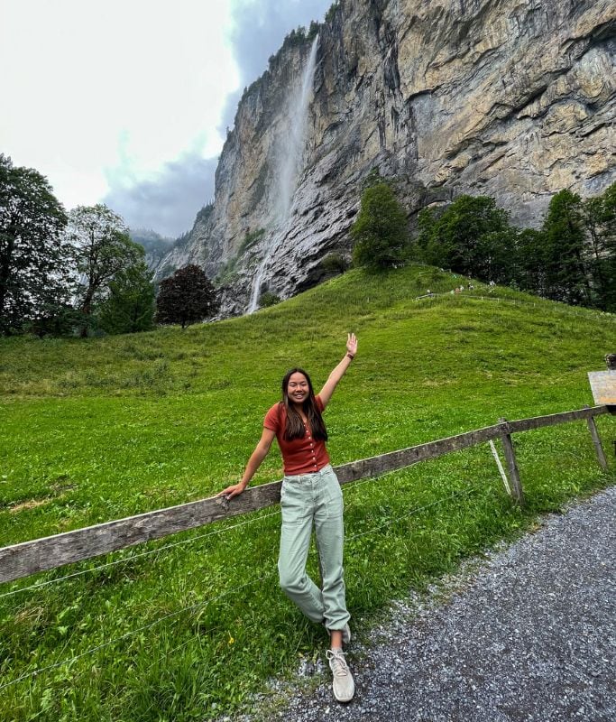 A picture of Kristin standing with the famous Staubbach Waterfall in the background.